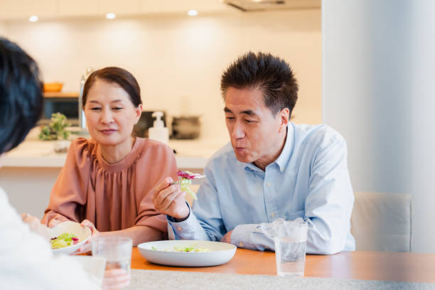 istock Large family eating dinner together 1689862563