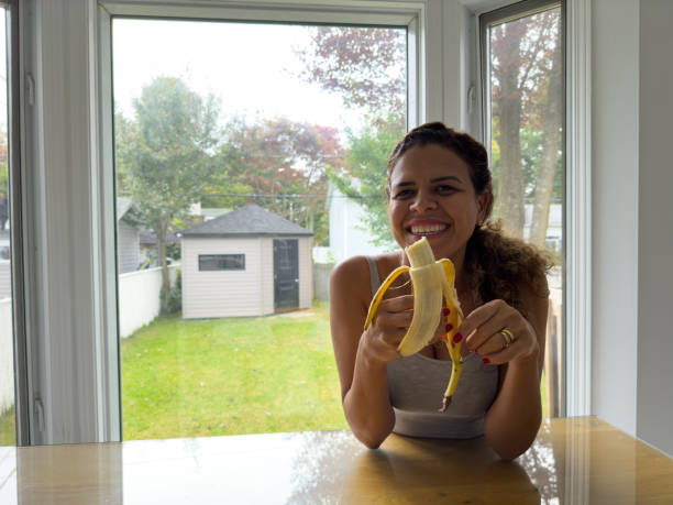 istock Woman eating a banana 1689862683