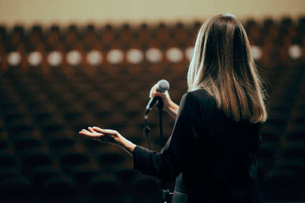 istock Motivational Speaker Rehearsing Presentation in Empty Theater Room 1689871152