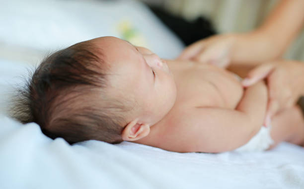 istock Adorable infnat baby boy lying on bed. 1689877291