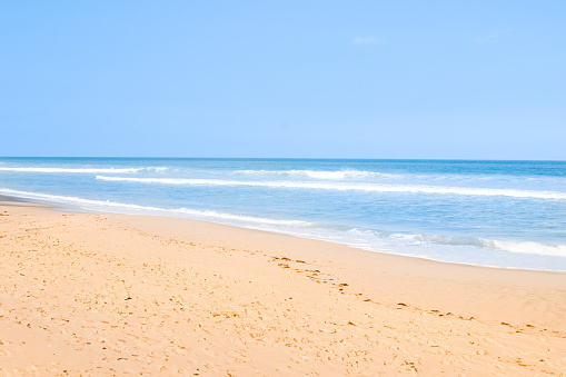 A perfect empty yellow sand beach.