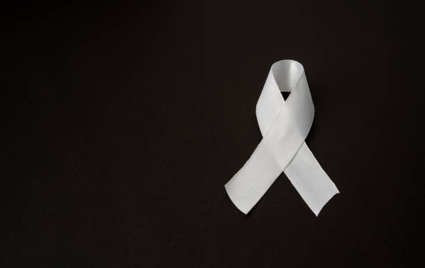 Top view of a white ribbon on a black background