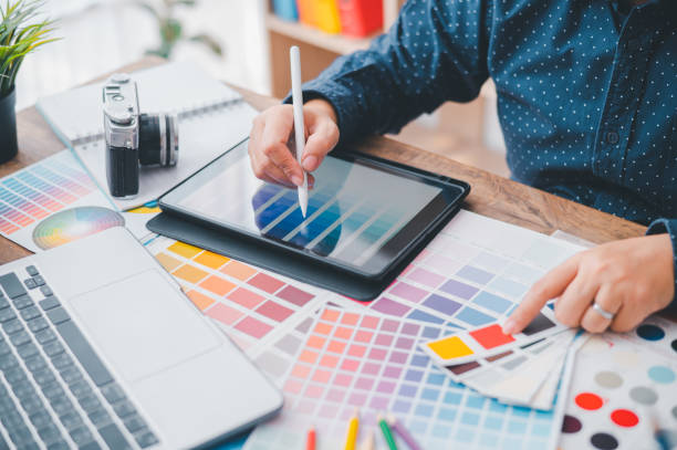 istock Graphic designer architects who work with laptops and color comparison tables for design work. 1689935646