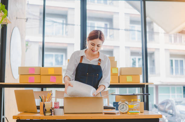 istock Online small business owners are packing their ordered products into the boxes for their customers based on the concept of online shopping - online shopping. 1689936177