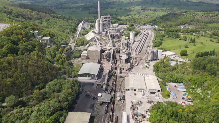 Aerial drone flight with a slow revealing shot of Breedon Hope Cement Works with a panoramic view of the surrounding Peak District.