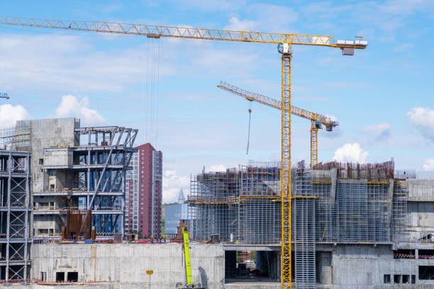 istock crane and a building under construction against a blue sky background 1689973575