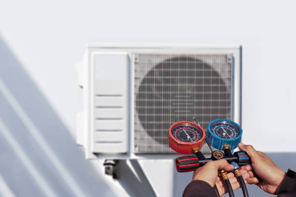 istock Air conditioning, HVAC service technician using gauges to check refrigerant and add refrigerant. 1689977716