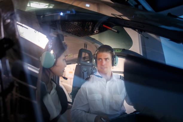 istock Pilot giving flying lesson to a female trainee pilot in a helicopter simulator 1689981573
