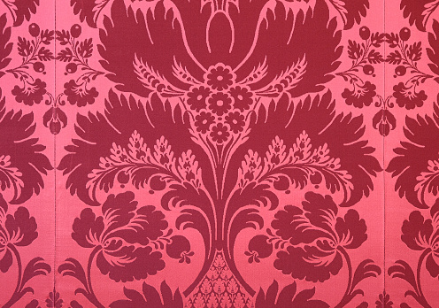 Close up of noble flower motif on wallpaper.