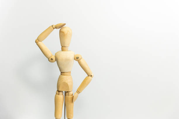 istock wooden mannequin raise its arms, giving speech 1689988577