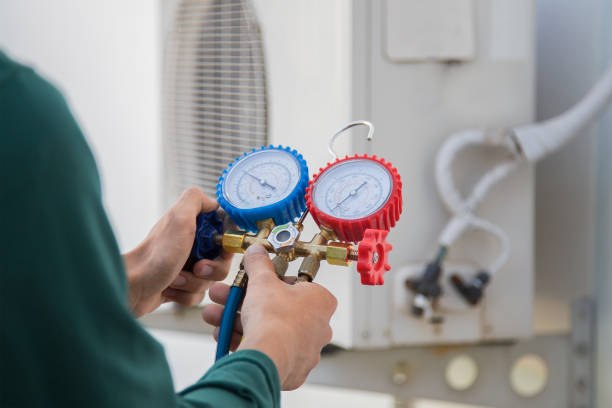 istock Air conditioning, HVAC service technician using gauges to check refrigerant and add refrigerant. 1689989094