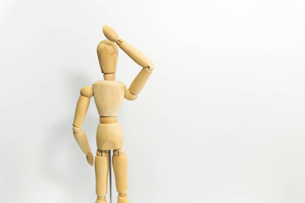 istock wooden mannequin raise its arms, giving speech 1689989097