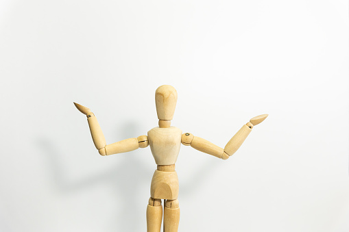 wooden mannequin holding its head, white background, public speaking event