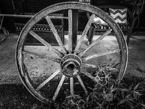 An antique farm wagon wheel serves as a reminder of days gone by.