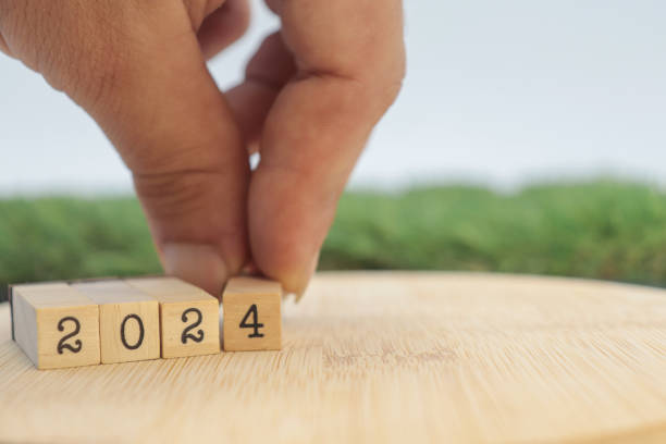 istock hand choosing the new year number 2024 1689990204