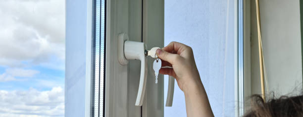 istock Child opens window with lock closeup. Window with child safety lock 1689991667