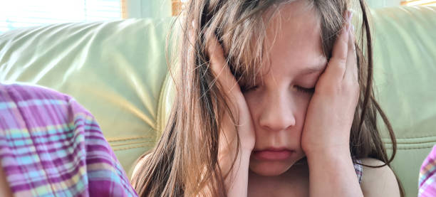 istock Beautiful little sad girl with headache and childish problem 1689991679