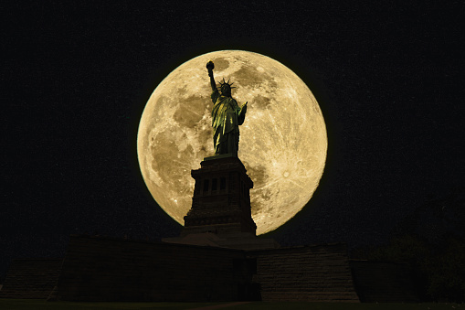 Statue of Liberty  back lit by the full moon