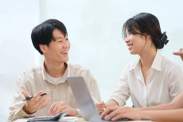 istock Two business colleagues sharing ideas or startup business plan at modern office. 1689993346