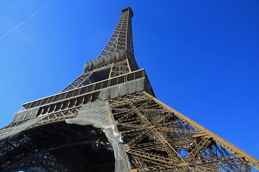 Historic Eiffel Tower (Tour Eiffel) from 19th century standing on Champs de Mars in Paris, France