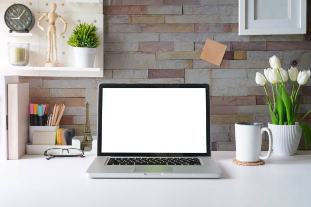 istock Laptop computer, picture frame, houseplant and stationery on white table. Modern workplace. 1690006715