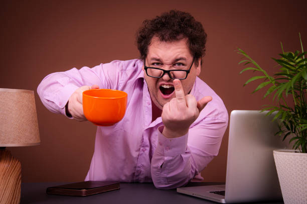 istock Funny fat man posing at a table with a laptop. Hard work online early morning 1690021804