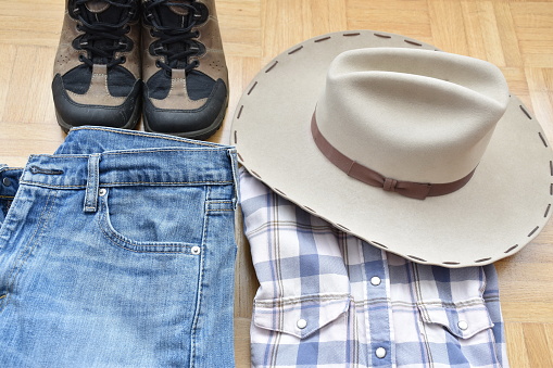 High angle view of jeans, shirt, shoes and cowboy hat
