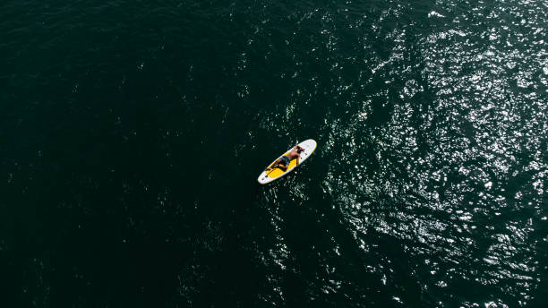 istock Young man is laying on SUP 1690062761