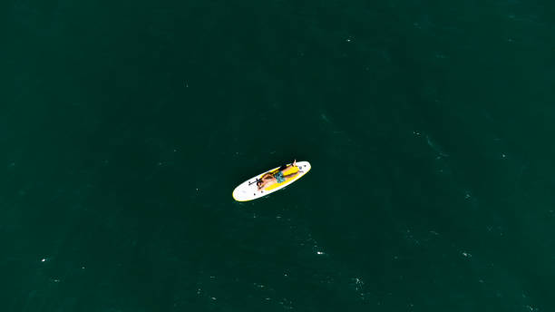 istock Young man is laying on SUP 1690062779