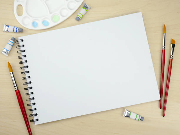 istock Sketch book with paint accessories on wooden texture background, Mock up template, Flat Layout 1690081911
