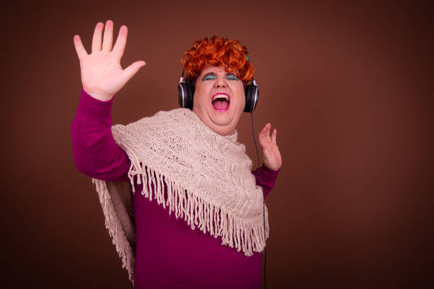 istock Drag queen posing in the studio against a brown background. 1690103884