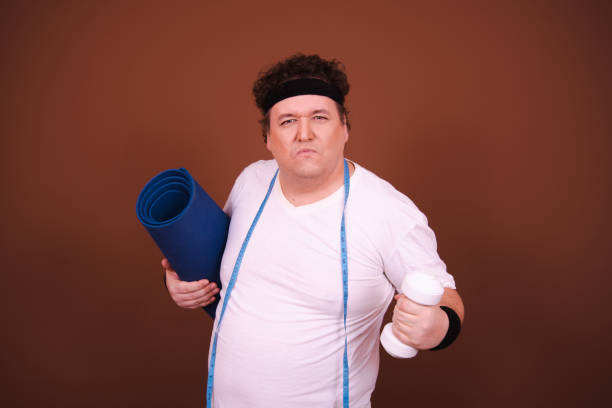 istock Funny fat man doing fitness. Stormy emotions and different situations. 1690105048