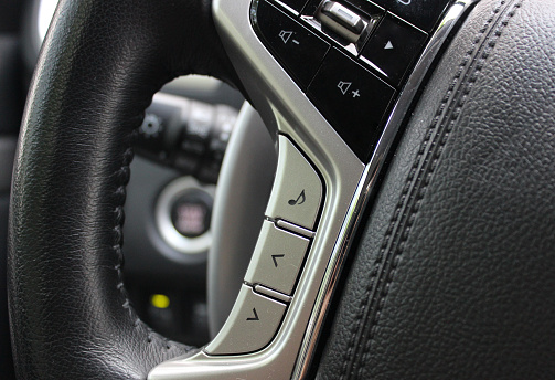 Control buttons for the volume of the sound system and voice control on the steering wheel of the vehicle