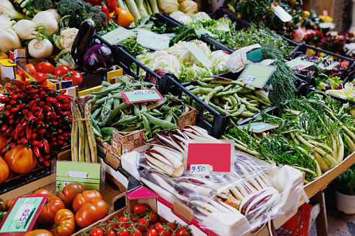 Traditional green and food market stall with various fresh vegetables in Bologna, Italy