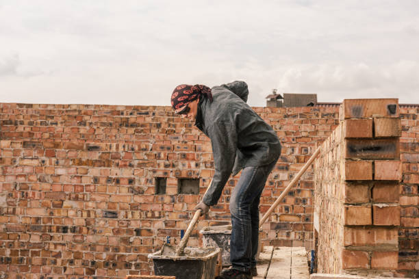 istock An experienced worker works on the construction of a brick house 1690124177