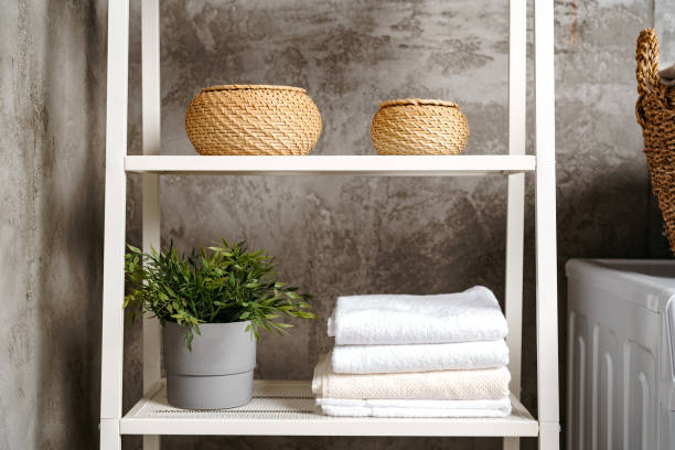 istock Clean folded towels on shelf in a bathroom 1690161871