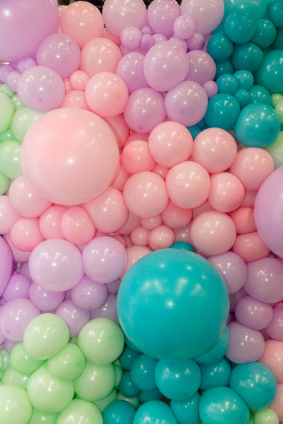 istock Many colorful balloons decorated wall as background 1690163544