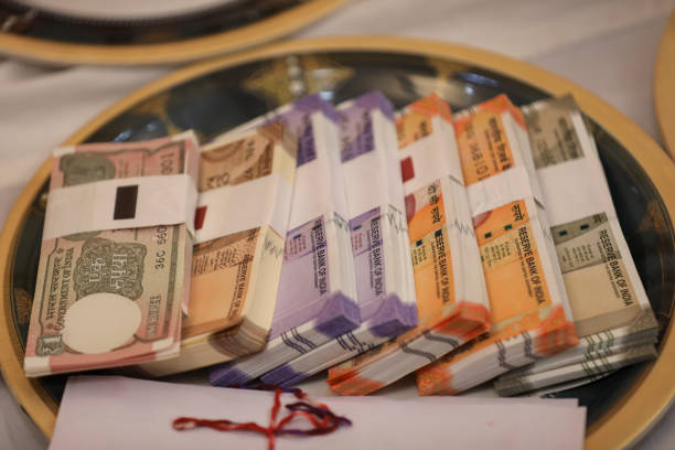 istock ndian 1, 10, 100, 200, 500 rupee notes in plate, A ritual of wedding programme. 1690167000