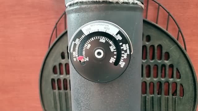 Magnetic temperature gauge attached to antique cast iron stove chimney
