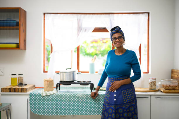 trzy czwarte długości portret babci w tradycyjnych strojach stojący w kuchni - africa african descent cooking african culture zdjęcia i obrazy z banku zdjęć