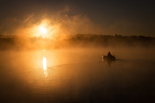 Fisherman sails his boat in the morning and fishing