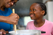 Close up happy young girl cooking with grandmother