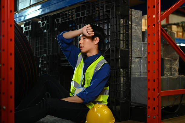 istock Tired male worker leaning against rack, taking break and wiping sweat from forehead 1690273409