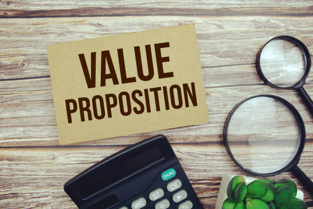 istock Value Proposition text message with calculator and magnifying top view on wooden background 1690284880