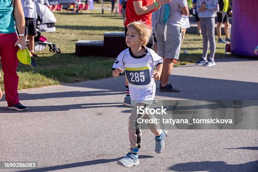 Young preschool children, running on track in a marathon competition