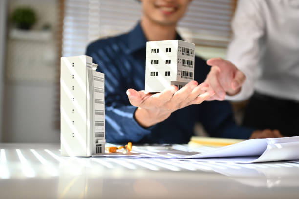 istock Architects team working on architectural model and discussing the new project at office 1690286474