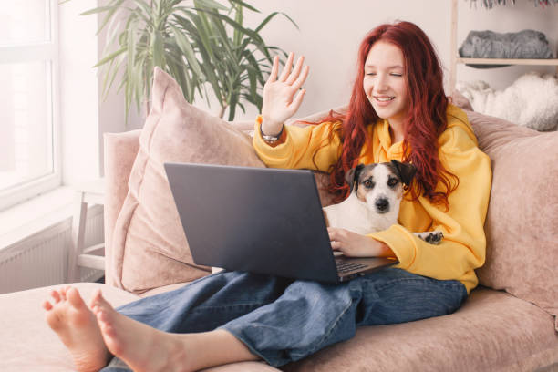 istock Smiling female student looking at laptop screen waving hand greeting tutor. 1690300064