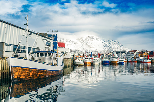 Fishing boats in the harbour of Henningsvaer a fishing village located on several small islands off the southern coast of Austvagoya in the Lofoten archipelago in Norway.