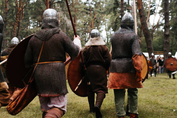 istock Back view of attacking medieval warriors in the forest. 1690316897