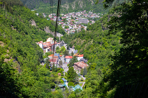 Borjomi town aerial view seen from cable car above the city, resort town in green Borjomi Gorge, Borjomi-Kharagauli National Park, Caucasus, Georgia.